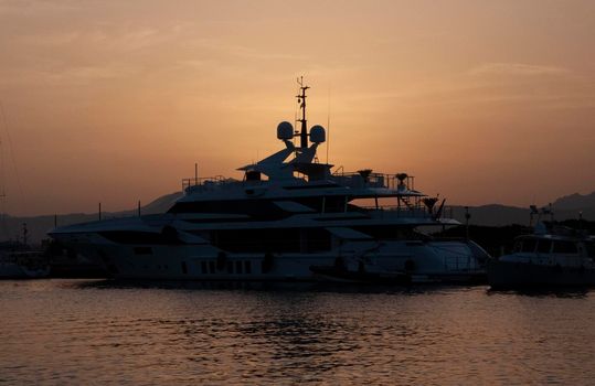 Olbia, Sardinia / Italy - 2019/8/21: Panoramic view of marina di Olbia port and yacht marina at sunset