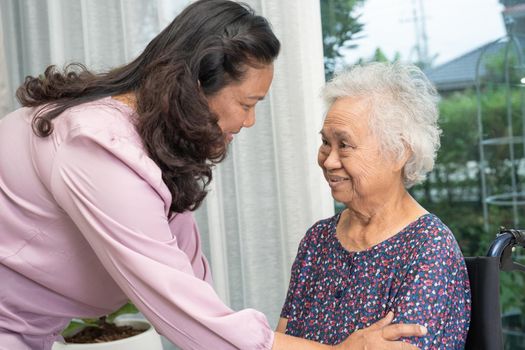 Help and care Asian senior or elderly old lady woman patient sitting on wheelchair at nursing hospital ward, healthy strong medical concept