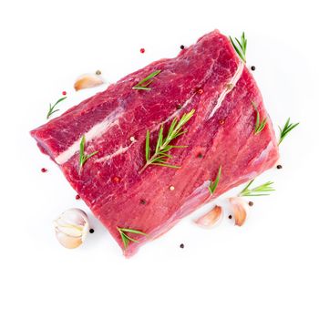 large piece of meat, raw beef fillet isolated on a white background. Striploin with rosemary and garlic seasonings, top view