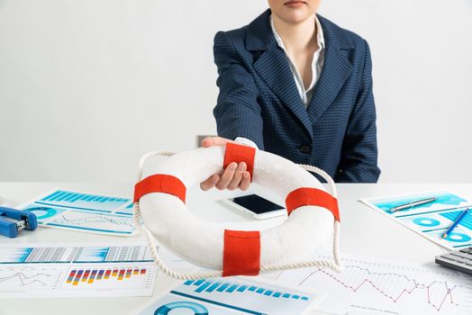 Woman consultant proposes lifebuoy as symbol of help. Business assistance and professional law consultation. Insurance services for business and life. Manager in suit sits at desk in office.
