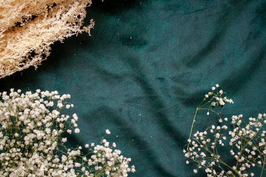 dried flowers on the background Luxury emerald green velour background.