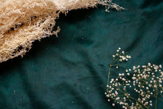 dried flowers on the background Luxury emerald green velour background.