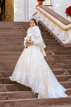 Newlyweds on the steps near the Orthodox Church