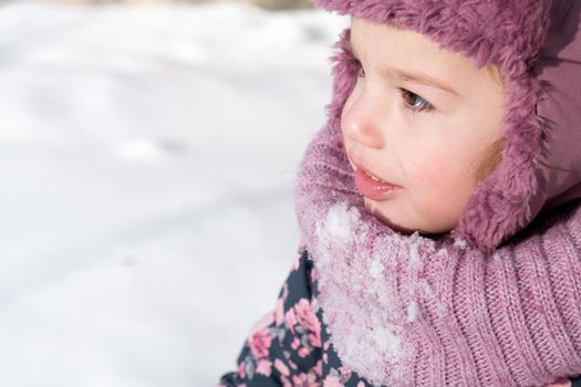 Winter, family, childhood concepts - close-up portrait authentic little preschool minor 3-4 years girl in pink hat look at camera posing smile in snowy frosty weather. happy kid face have fun outdoors.