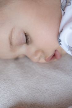 Childhood, care, motherhood, health, medicine, pediatrics concepts - Close up Little peace calm todler preschool girl sleeps resting take deep nap laying on tummy on soft bed. bedtime mod close eyes.