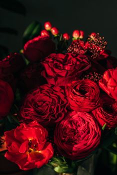 Bright red flowers bouquet on dark background.