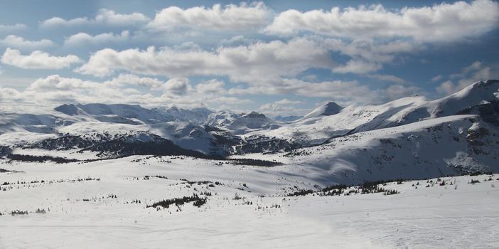 Panorama on a sunny day of a snow-covered mountain range