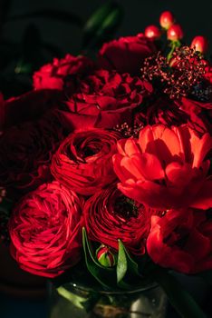 Bright red flowers bouquet on dark background.