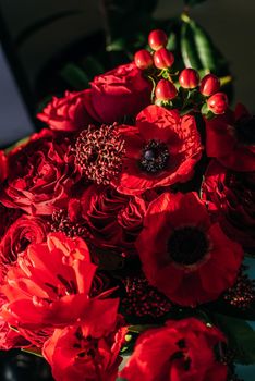 Bright red flowers bouquet on dark background.