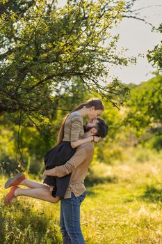 young couple hugging and kissing in nature