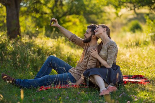 young couple taking a selfie in nature