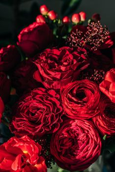 Bright red flowers bouquet on dark background.