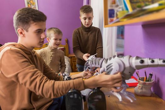 children play with different robots