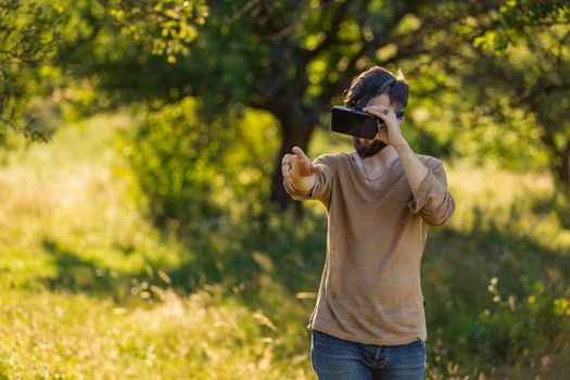 man wearing virtual reality glasses outdoors