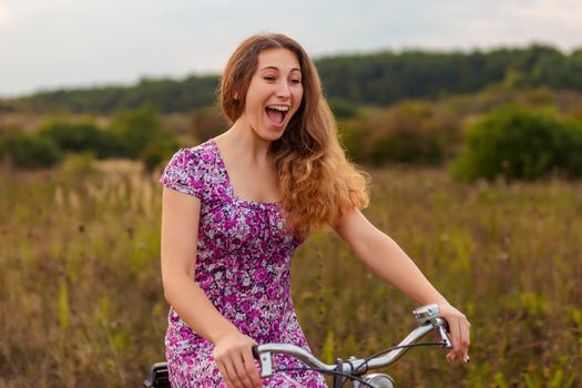 woman with bicycle walking in nature