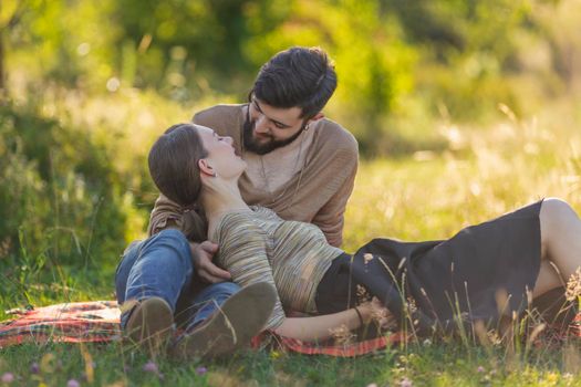 young couple sitting in nature and relaxing