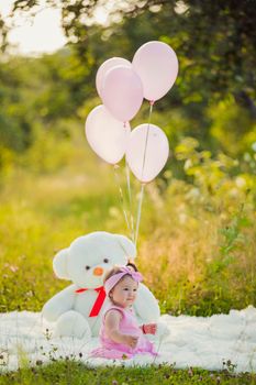 child with balloons in nature