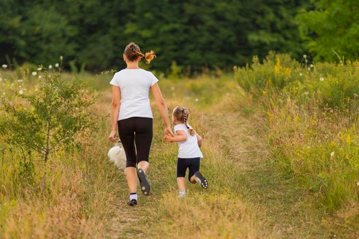 mother and daughter walking in nature