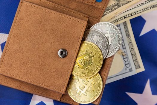 bitcoins in wallet on american flag close up
