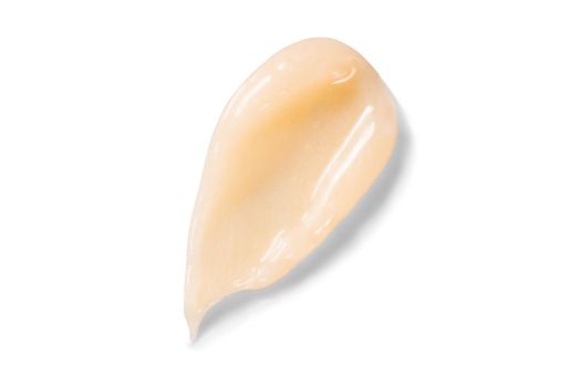 Hair conditioner cream swatch smear with shadow on white background. Yellow cosmetic lotion moisturiser sample closeup. Body care balm, retinol serum, shampoo wavy texture. Skincare mask