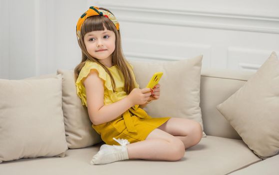 girl sitting with a phone in her hands