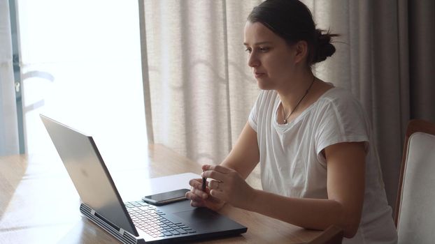 Authentic Stressful Woman working Chatting On Laptop Living Room. Writing Searching Using IT. Tired Sad Lady Working On Computer Internet On Comfortale Chair. Buisenes, Education, Technology Concept.