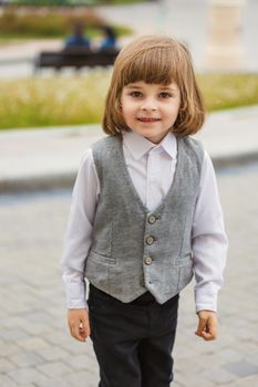 little boy standing in the street