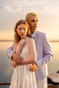 young couple in the seaport on the background of the sea