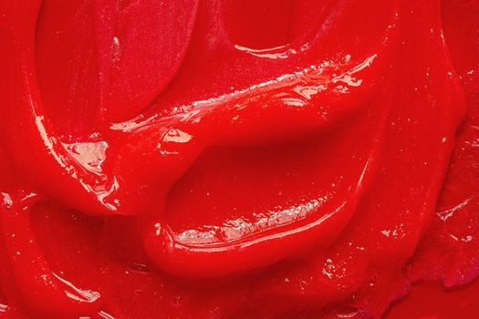 Red gel texture. Cosmetic clear liquid cream smudge. Skin care product sample closeup. Toothpaste or wax background