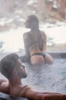 couple bathe in vats outdoors