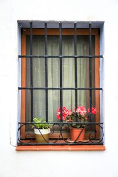 Whitewashed facade with window with forged metal grill in Altea village, Alicante, Spain