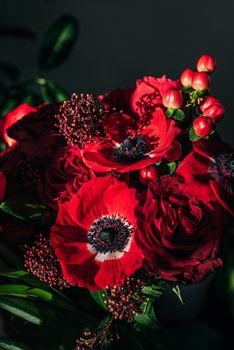 Bright red flowers bouquet on dark background.