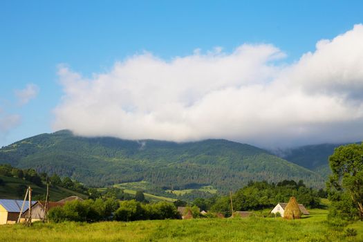 Haystack summer in the beautiful village Ukrainian Carpathians