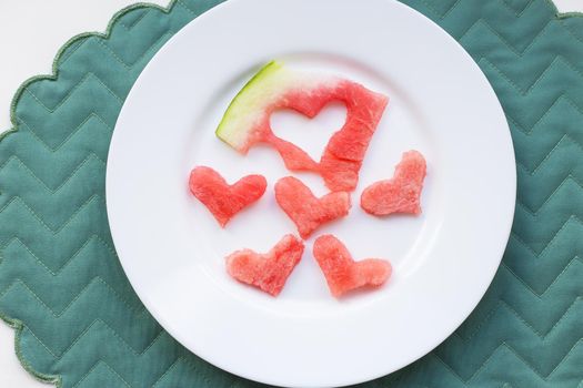 watermelon heart shape on a white plate. valentine card