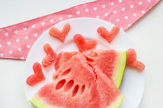 heart-shaped watermelon on a plate and napkin Pink. valentine card