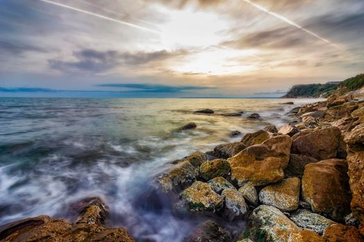 Beauty sea rocky coast with color moss on the stones. Black sea