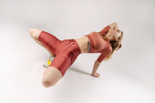 the athletic girl posing in the Studio on a white background