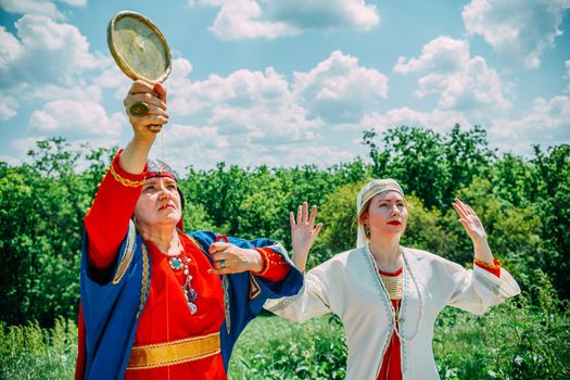 the senior priestess with her assistant prepared for the rite of sacrifice. mystical pagan rite. pagans today