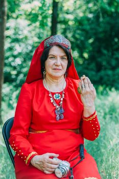 the senior priestess with a butterfly on her fingers prepared for the rite of sacrifice. mystical pagan rite. pagans today