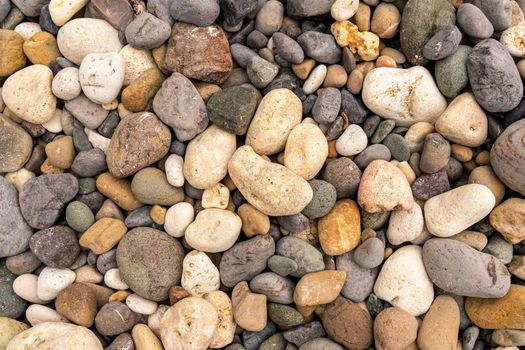 Sea pebbles. Small stones gravel background texture. A pile of pebbles on the beach. Texture, background for designers