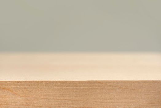 Wooden board empty table in front of a blurred background. Perspective of a wooden table in front of a blurred background for your layout or product presentation.