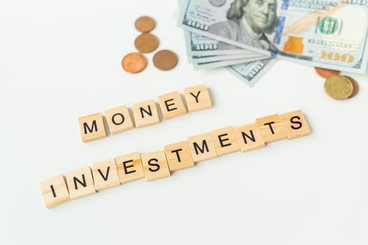 International currency money including euro, dollar, coin, dollar bill. The inscription in wooden letters money investments. The concept of investments, loans, debts