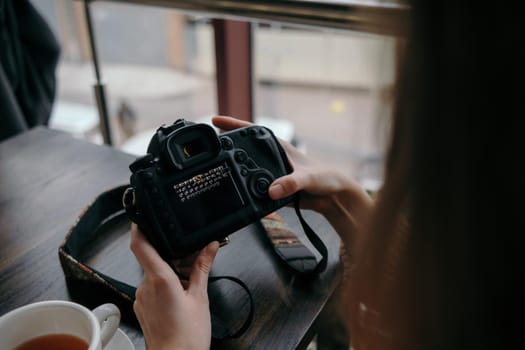 girl watching photos on a camera close