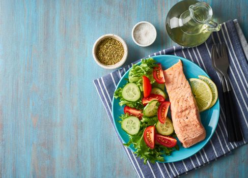 Steam salmon and vegetables, Paleo, keto, fodmap diet. Blue plate on blue table, top view