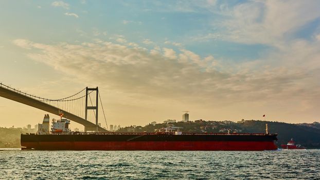 Cargo ship tanker in Bosphorus Strait about to pass under Bosphorus bridge in Istanbul, Turkey