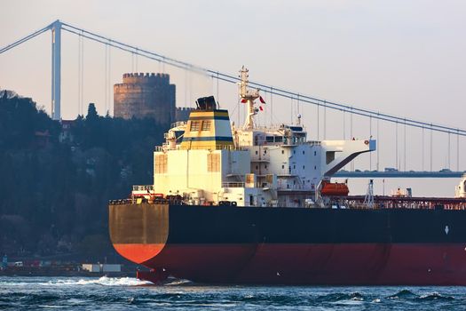 Cargo ship tanker in Bosphorus Strait about to pass under Bosphorus bridge in Istanbul, Turkey