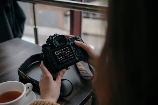 girl watching photos on a camera close