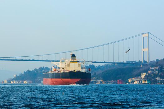 Cargo ship tanker in Bosphorus Strait about to pass under Bosphorus bridge in Istanbul, Turkey