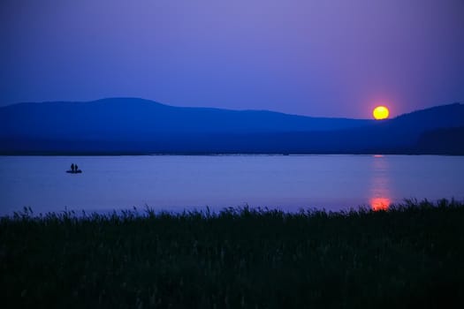 Sunset in the bay against mountainous background.