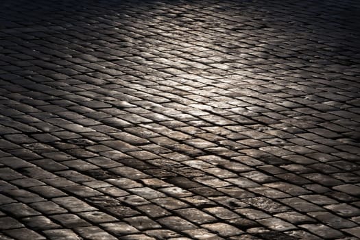 old stone granite pavement. Background close-up.